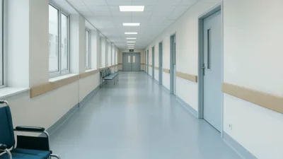 Empty Hospital Corridor With Wheelchair Moving Through Hallway