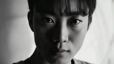Young Asian Man Looking Directly Into Camera Lens
