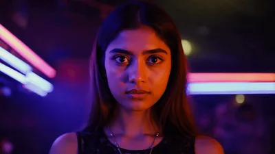 Young Woman Staring Intensely In A Neon Lit Nightclub