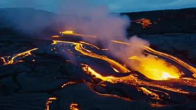 Aerial View Of Active Lava Flowing Over Volcanic Landscape