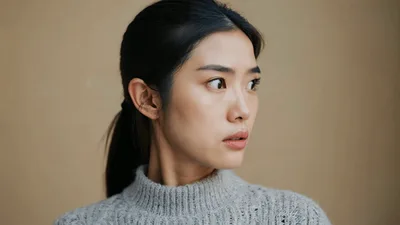 Young Asian Woman Looking Away With Concerned Expression
