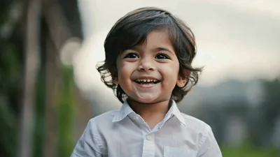 Happy Toddler Boy Smiling Outdoors In Soft Natural Light