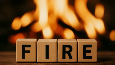 Wooden Blocks Spelling Fire In Front Of A Fireplace