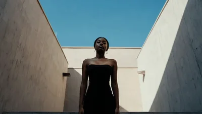 Young Black Woman Standing Still In Modern Architectural Space