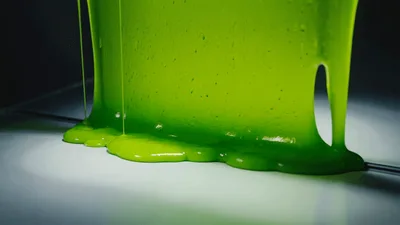 Thick Green Slime Dripping Down A Metal Surface