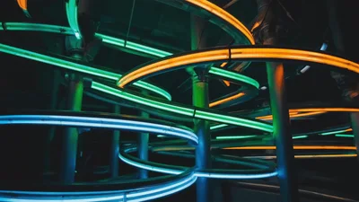 Neon Spiral Tracks With Glowing Lights In Dark Space