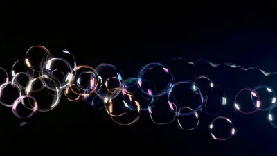 Floating Iridescent Soap Bubbles Against Dark Background