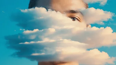 Surreal Portrait Of Man Merging With Moving Clouds