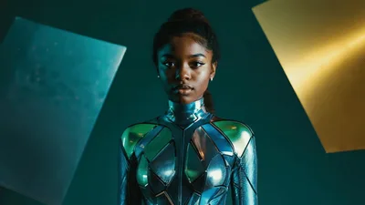 Futuristic Woman In Metallic Armor Blinking In Studio