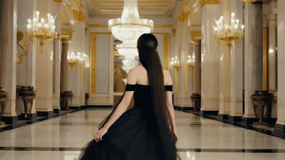 Elegant Woman In Black Gown Walking Through Palace Hall