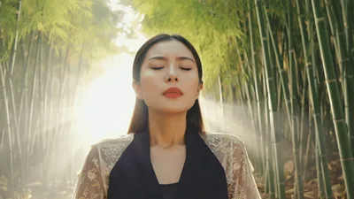 Young Asian Woman Meditating In A Bamboo Forest