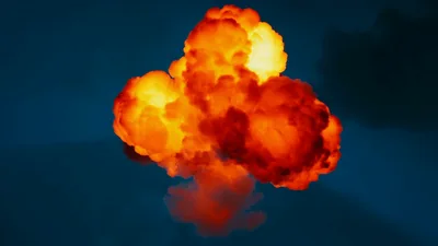 Large Fiery Explosion Expanding Against Dark Blue Background