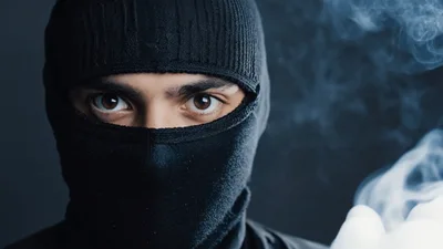 Man Wearing Black Balaclava Exhaling Thick White Smoke