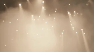Golden Stage Lights Shining Through Atmospheric Haze