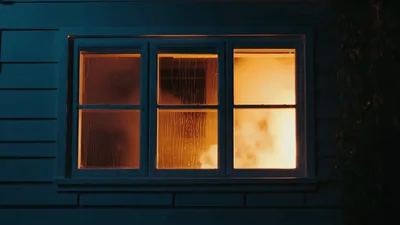 House Window Burning With Intense Fire Inside