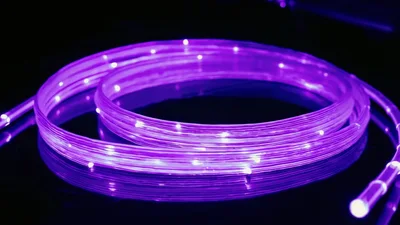 Purple Fiber Optic Light Strip Coiled On Reflective Surface