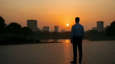 Businessman Standing Alone Watching Sunset Over City Skyline