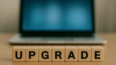 Wooden Blocks Spelling Upgrade In Front Of Laptop