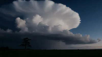 Supercell Thunderstorm Cloud With Lightning Strikes Over Field