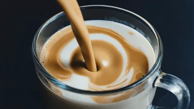 Coffee Pouring Into A Glass Mug With Milk