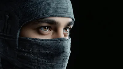 Close Up Of A Ninja Blinking In Dark Background
