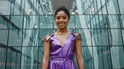 Young Woman In Purple Dress Smiling At Camera