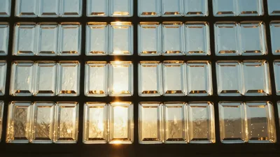 Golden Sunlight Shining Through Rectangular Glass Block Window