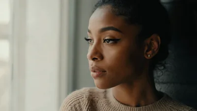 Young Woman Looking Out The Window Thoughtfully