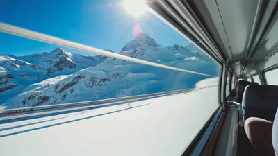 Scenic Train Journey Through Snowy Swiss Alps Mountains