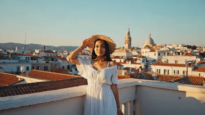 Young Woman Posing On Rooftop Overlooking Lisbon Cityscape