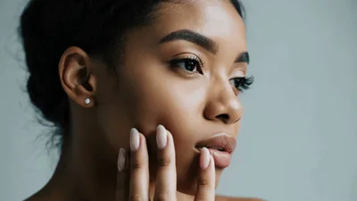 Young Woman Touching Her Smooth Skin On Face