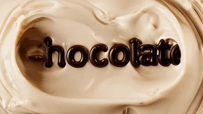 Chocolate Text Appearing In Swirling Creamy Liquid