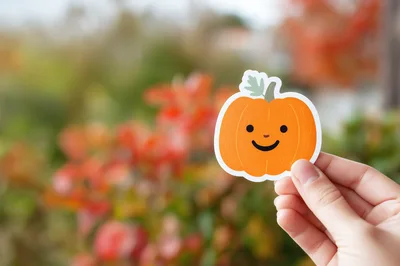 Hand Holding A Cute Pumpkin Sticker