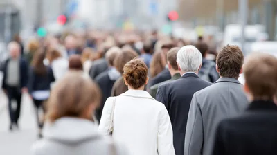 Commuters Walking Through A Busy City Street