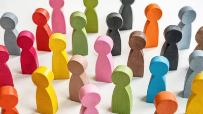 Colorful Wooden Figurines Arranged On White Surface