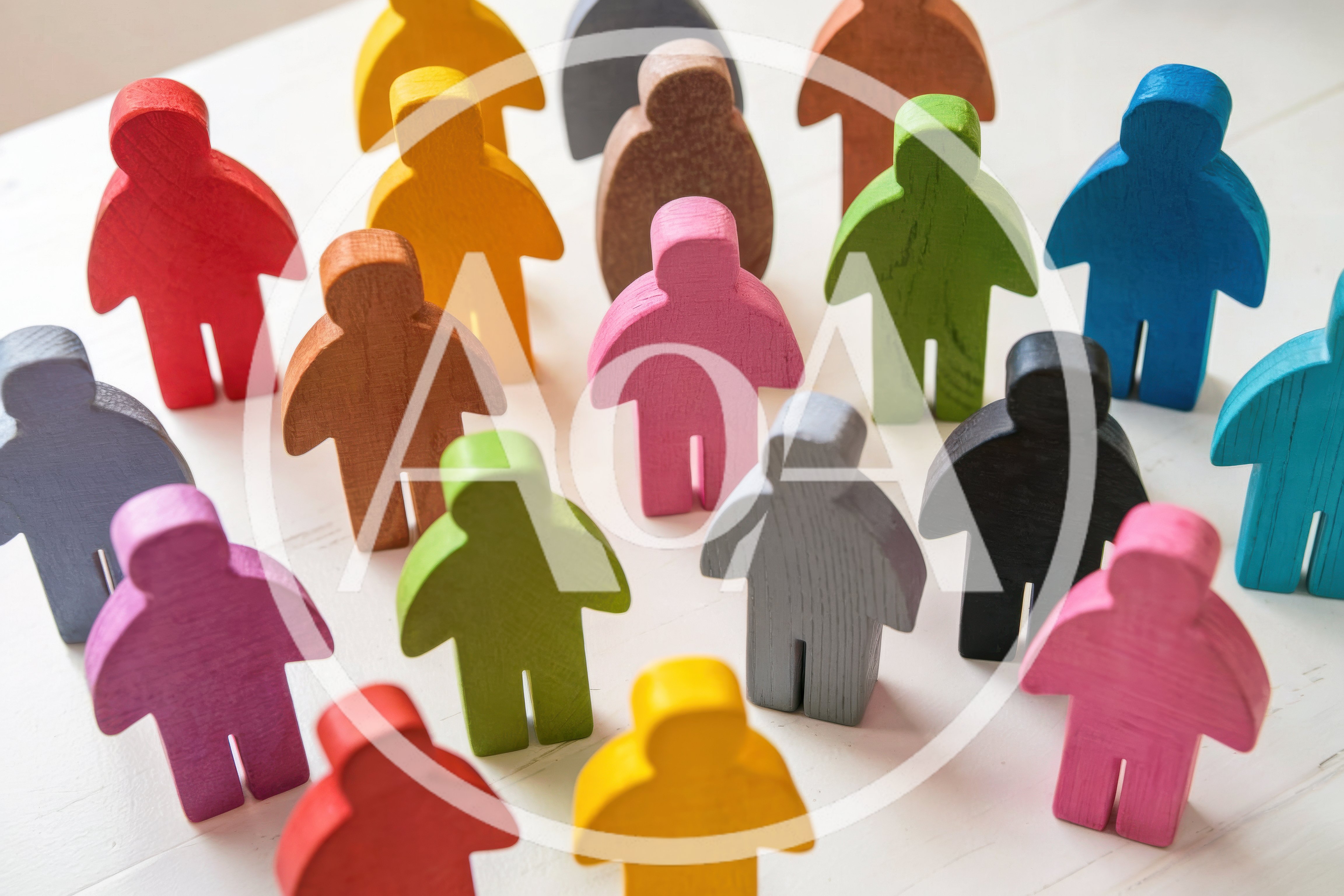 Colorful Wooden Human Figurines Arranged On White Surface
