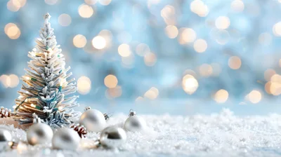 Miniature Christmas Tree With Silver Ornaments On Snow