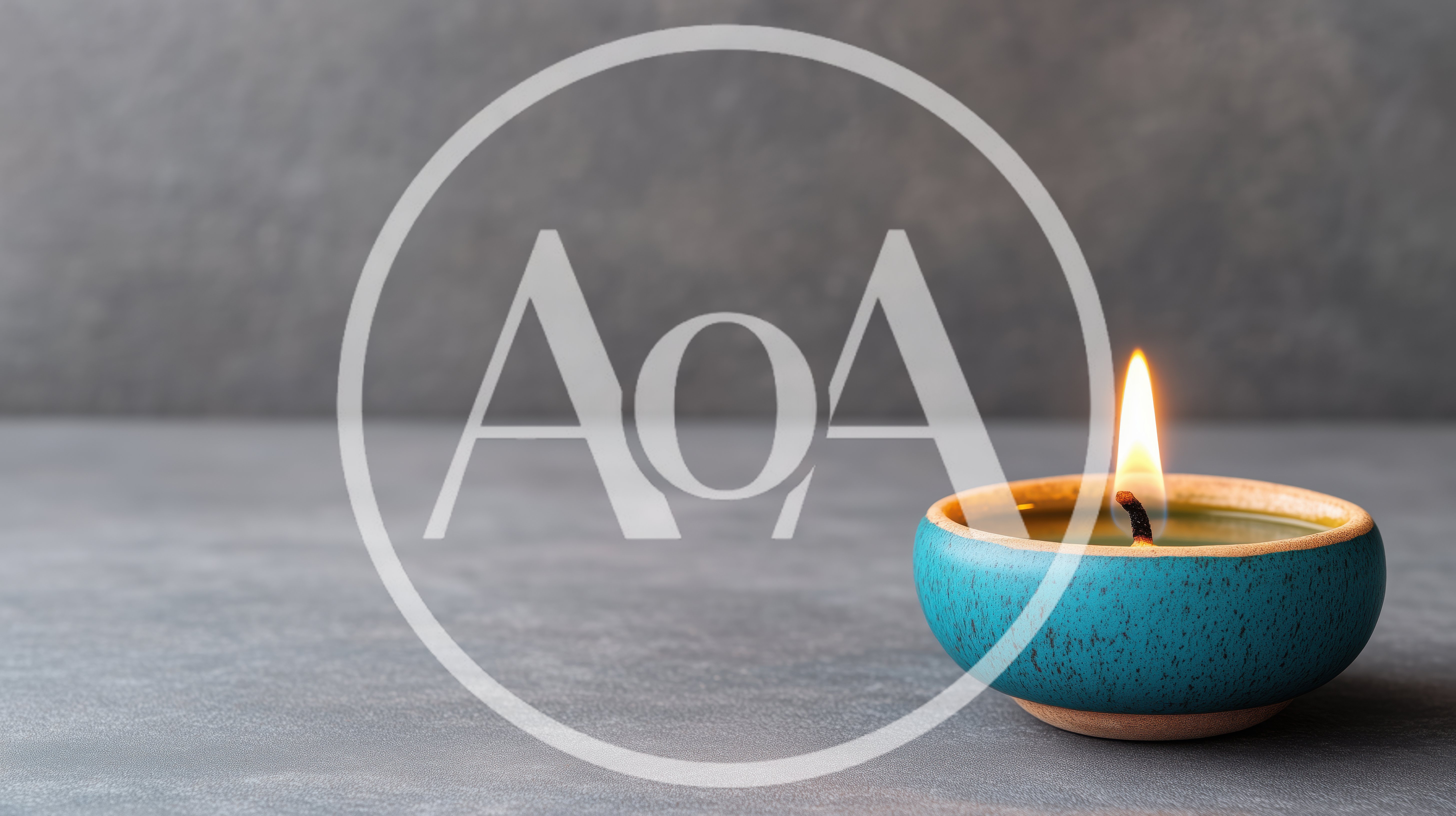 Lit Teal Ceramic Candle On Grey Surface