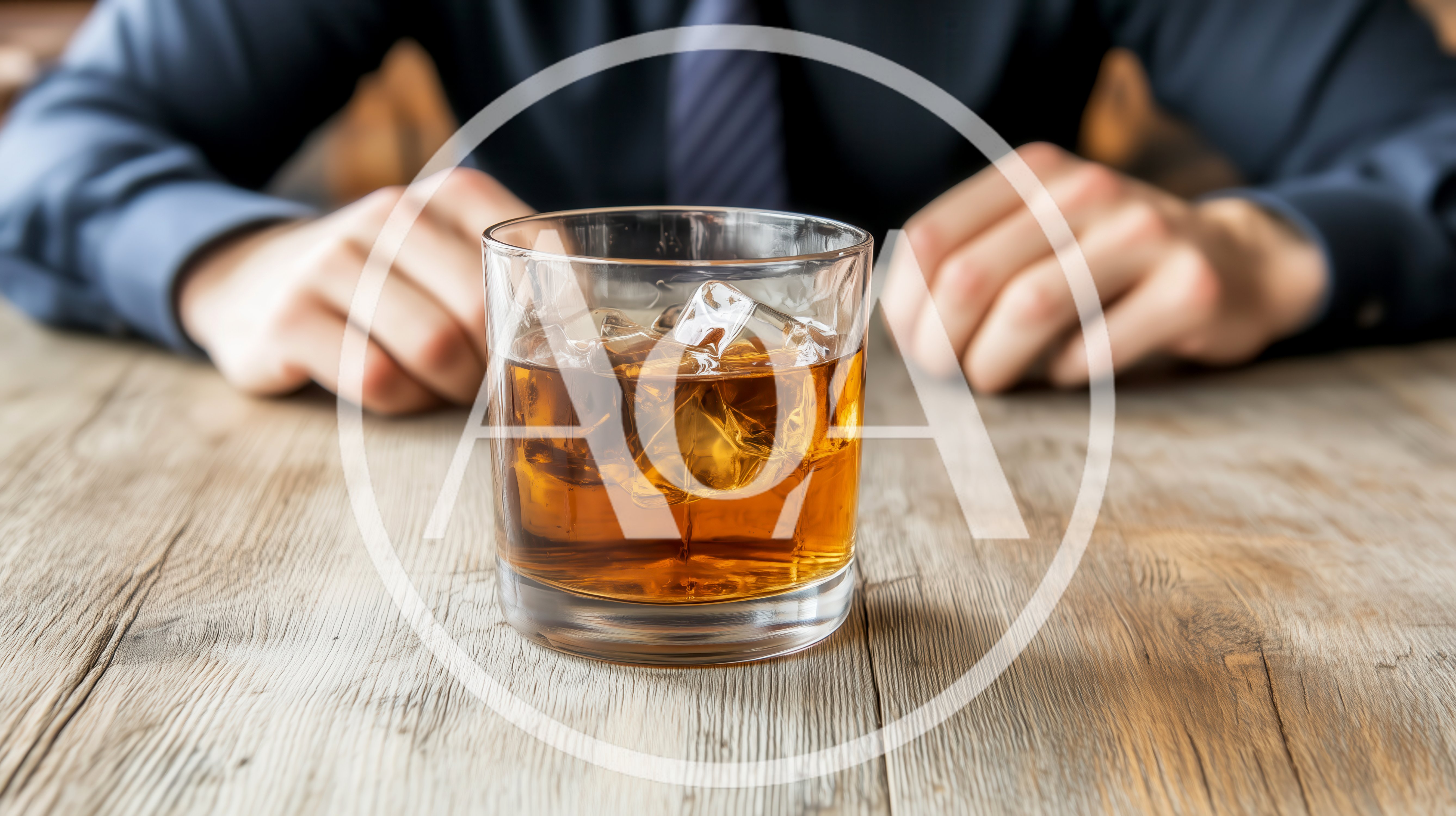 Businessman Sitting At A Wooden Table With Whiskey