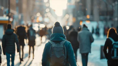 Person Walking Through A Crowded City Street In Winter