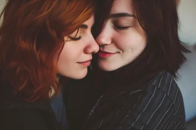 Two Women Embracing With Eyes Closed