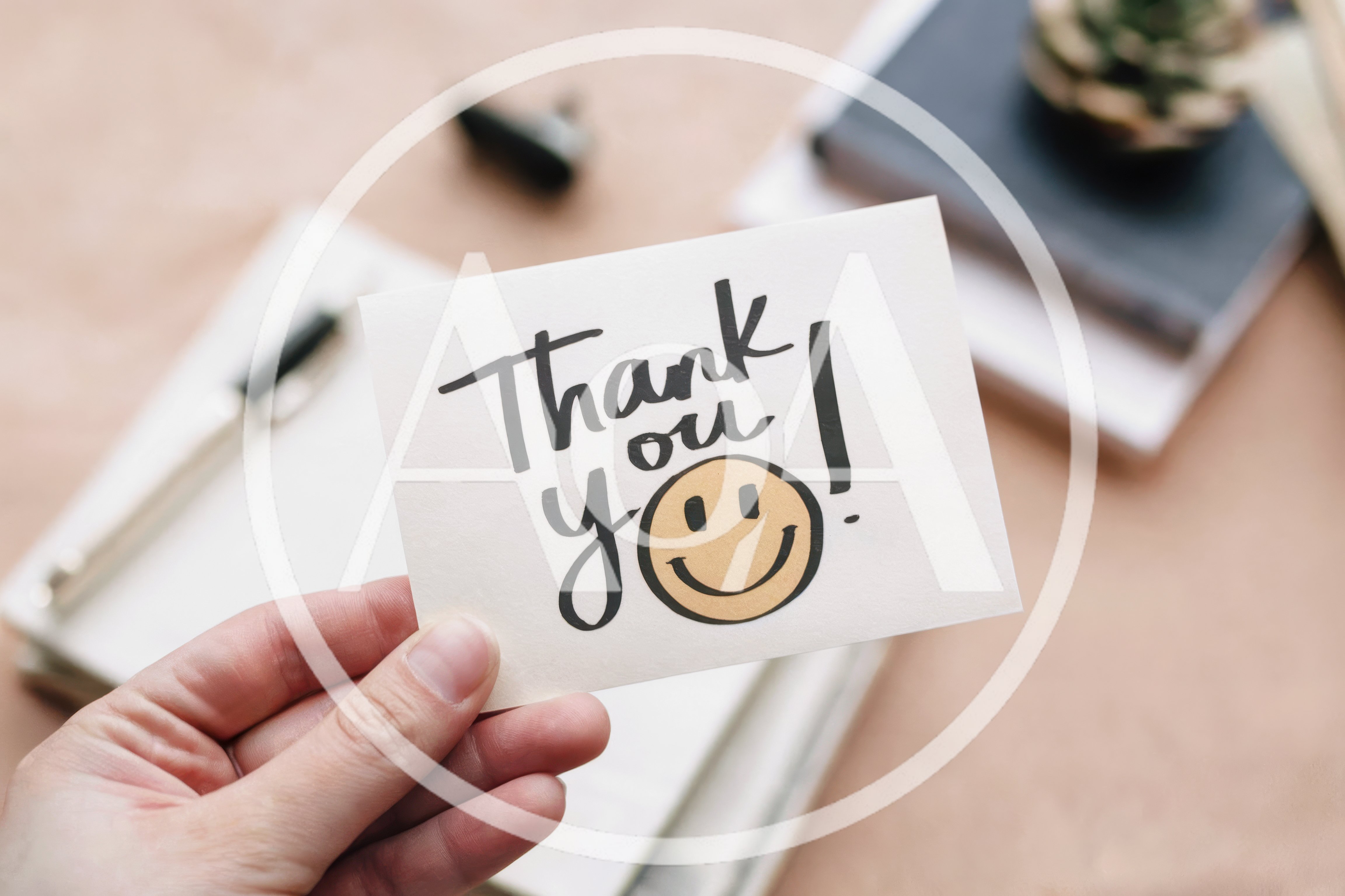 Hand Holding A Thank You Note With A Smiley Face