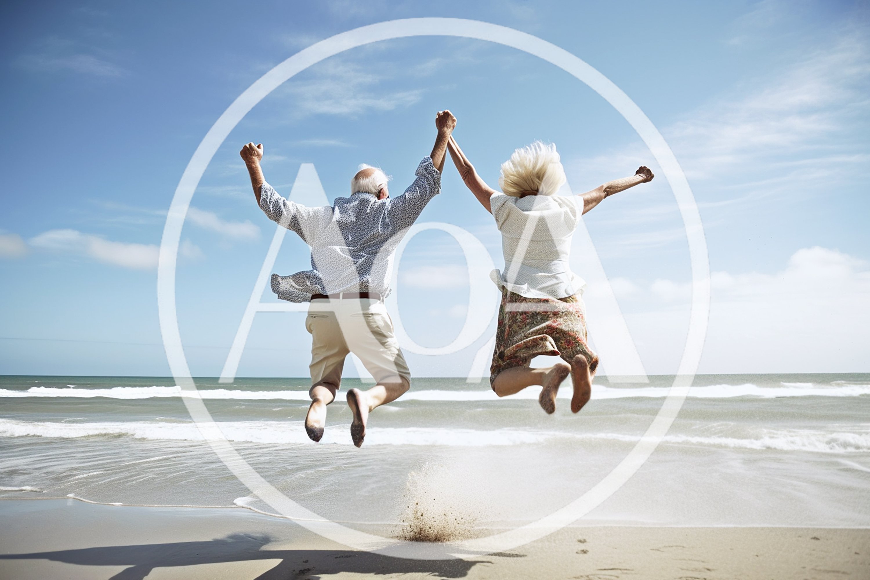 Senior Couple Jumping For Joy On The Beach