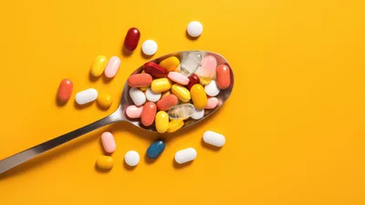 Assorted Colorful Pills and Capsules on a Metal Spoon