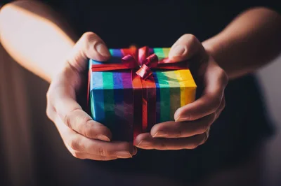 Person Holding A Rainbow Gift Box
