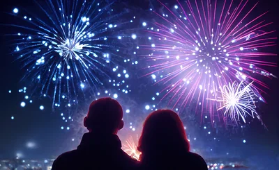 Couple Watching Fireworks Display At Night
