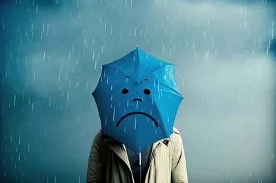 Person Holding Blue Umbrella With Sad Face In Rain