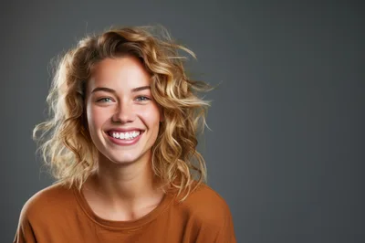 Portrait Of A Smiling Young Woman With Curly Hair