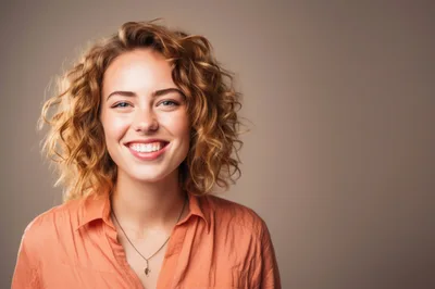 Portrait Of A Smiling Young Woman With Curly Hair