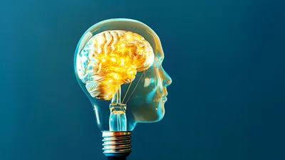 Human Head Shaped Light Bulb With Glowing Brain